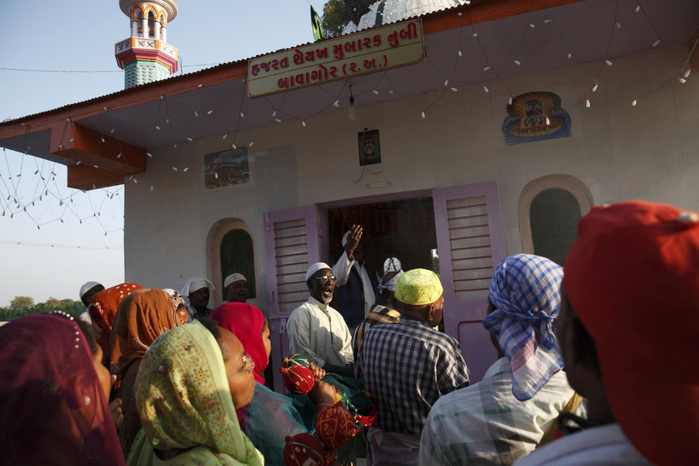 Members of the Sidi community gather at the Bava Gor shrine during the anual Urs celebration. Happening only once a year and lasting several days they give offerings to their Saint Bava Gor.