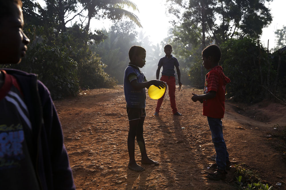 Sidi children play outside their homes with a balloon in the town of Yellapur. Uttara Kannada, India